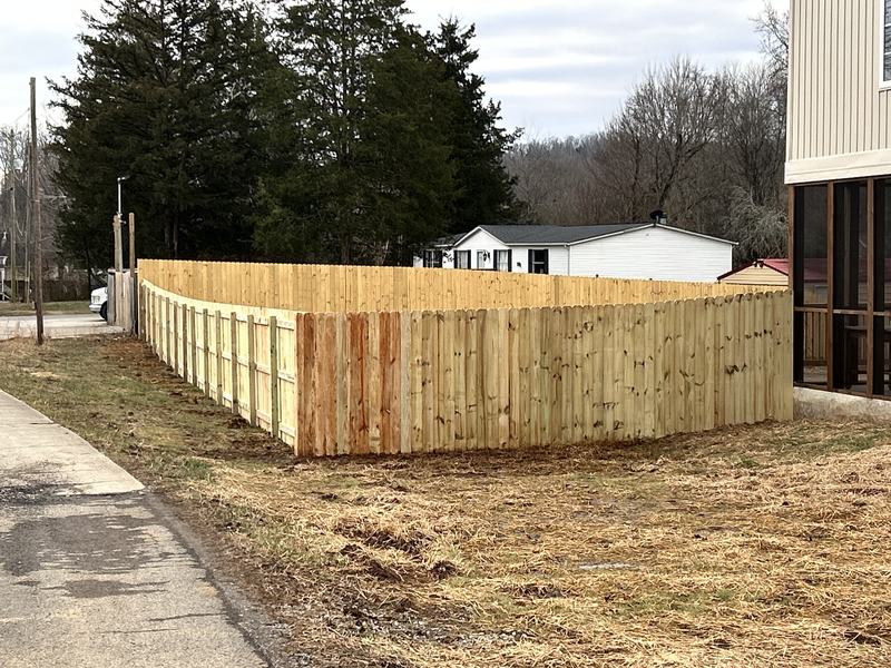 Wood privacy fence along the sidewalk on a corner lot