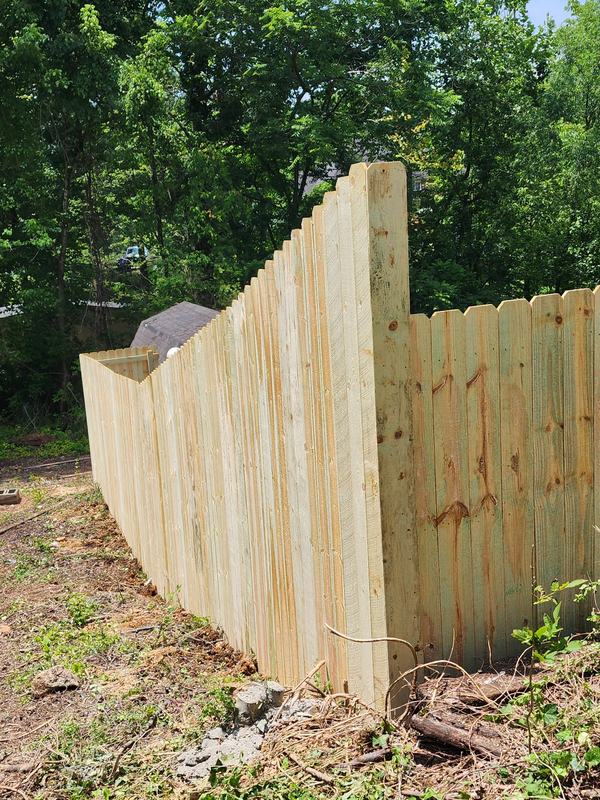 Wood privacy fence stepping down a slope